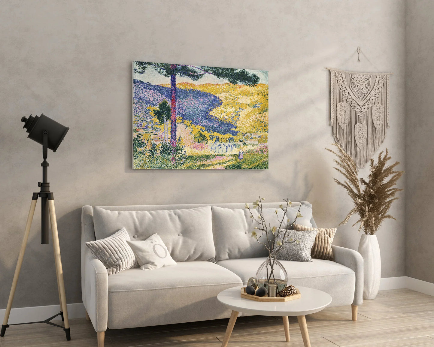 Abstract landscape wall art print with vibrant fields and trees, displayed above a modern sofa in a cozy living room.