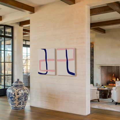 Two abstract art prints with pink and blue lines on a beige 