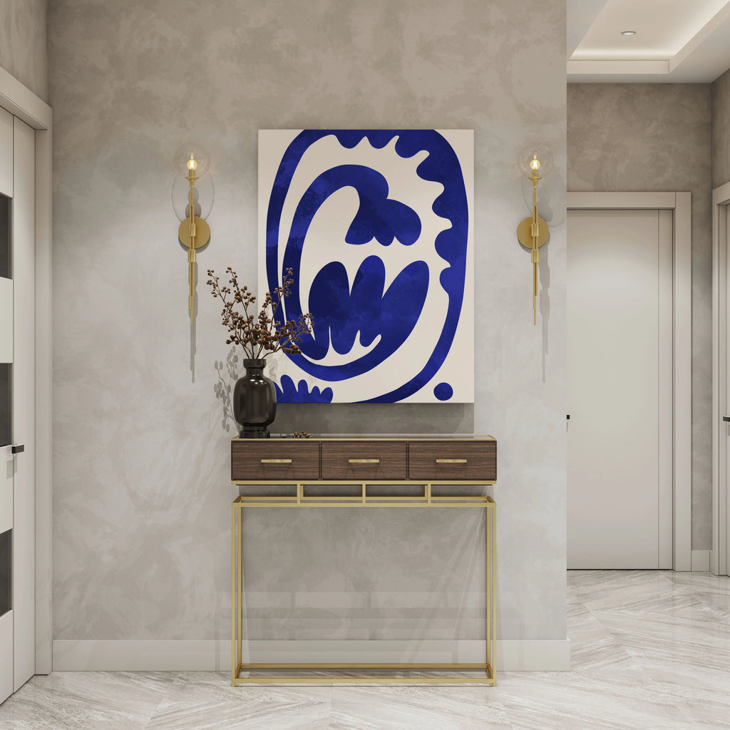 Blue abstract wall art print with modern decor, gold sconces, and console table in contemporary entryway