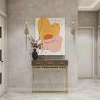 Abstract wall art with warm tones, modern console table, and gold sconces for stylish home decor